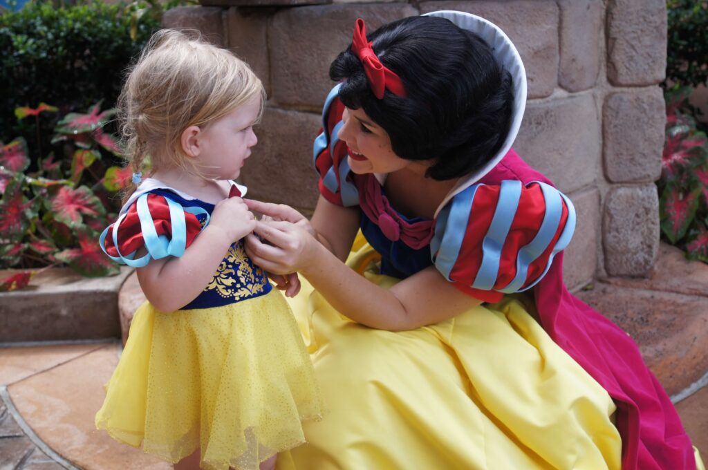 snow white and little girl dressed up like snow white at disney world magic kingdom