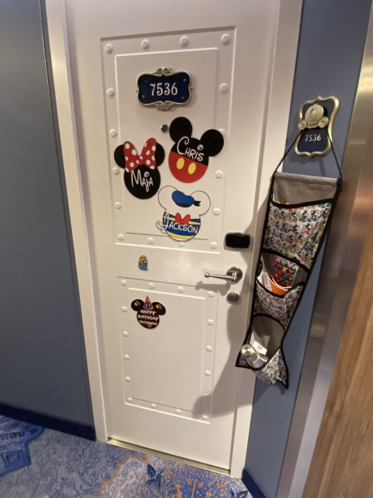 This is a simple door decoration where guests attach custom mickey and minnie magnets to decorate their door and add a fish extender to exchange gifts with other guests