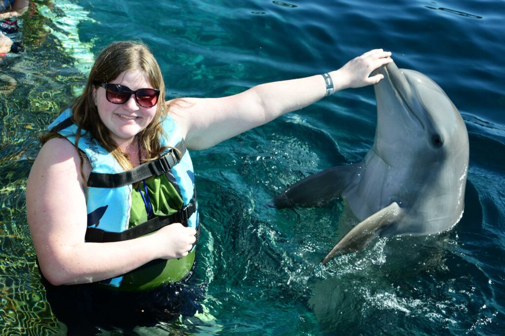 GIrl interacting with dolphin in Cozumen Mexico