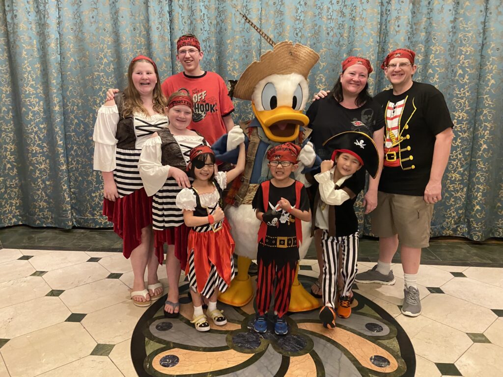 family with Donald Duck all in pirate costumes on the Disney cruise ship aka mickey boat