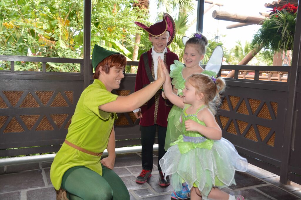 peter pan with little boy captain hook and two girls dressed as tinkerbell
