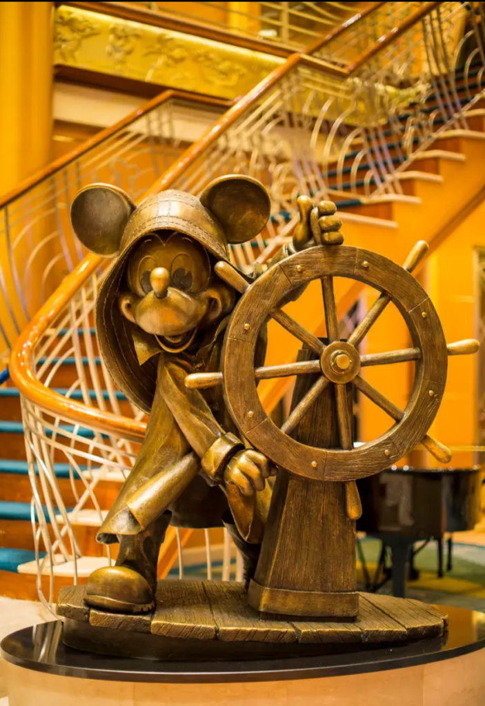 mickey statue in the main atrium of the disney magic cruise ship