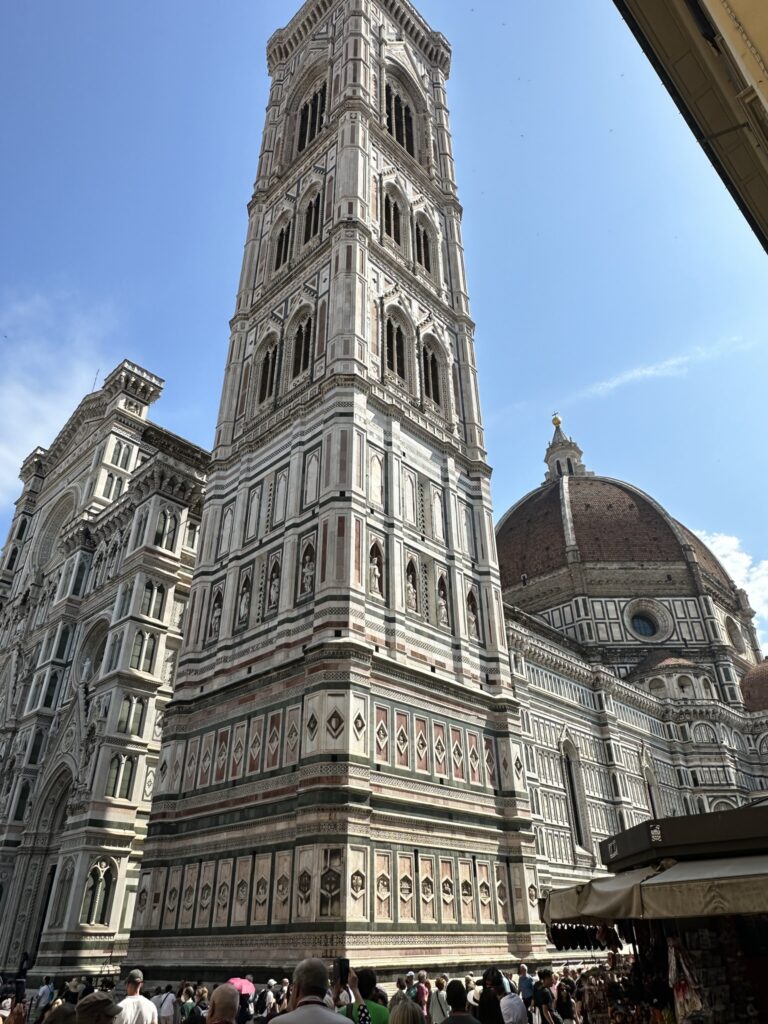 The majestic bell tower of the Cathedral – also known as “Giotto's Bell Tower” - is a masterpiece of the Italian Gothic. It has a square base of about 15 meters (49.2 feet) on each side, with corner reinforcing continuing all the way to the cantilevered horizontal crown, at 84.7 meters (278 feet) above ground.