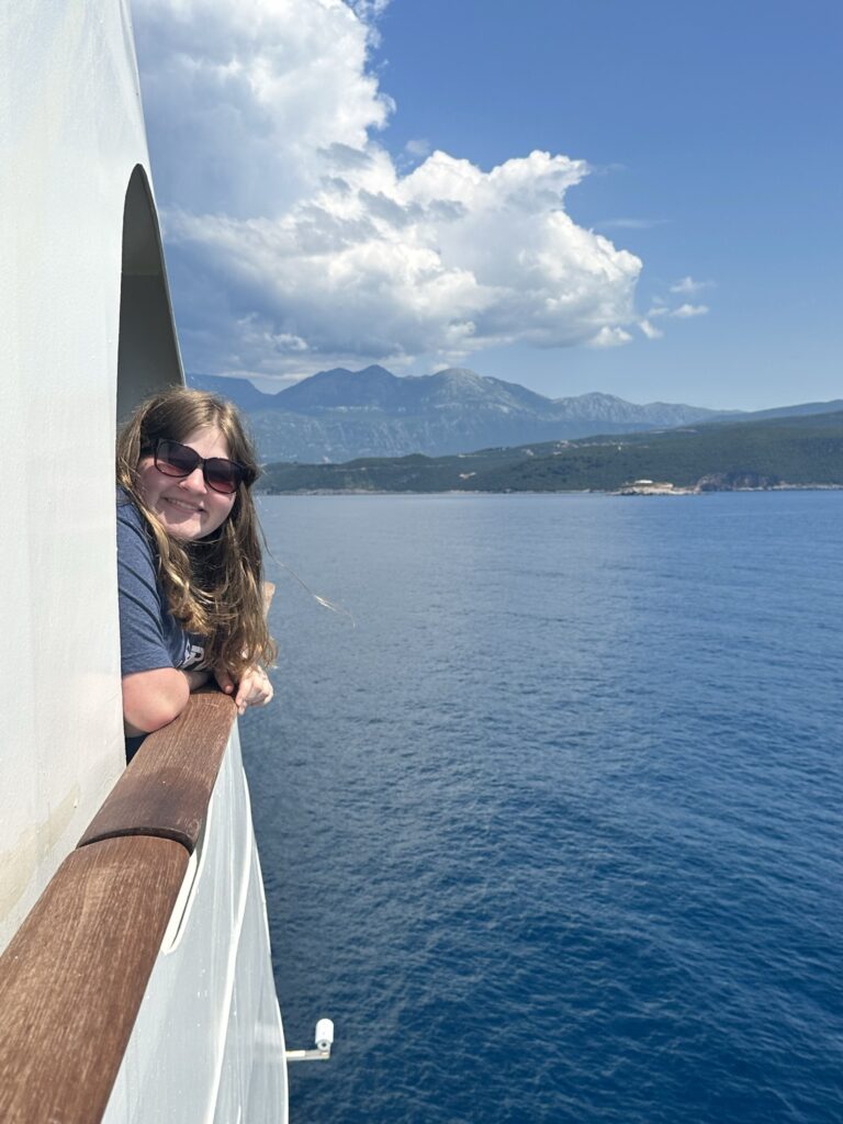 girl on a cruise with beautiful scenery around her