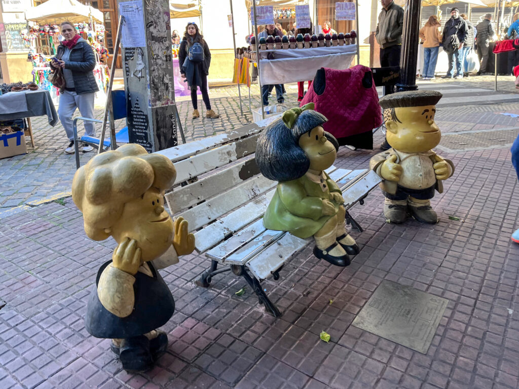 Tourists taking photos at the Mafalda monument, in San Telmo