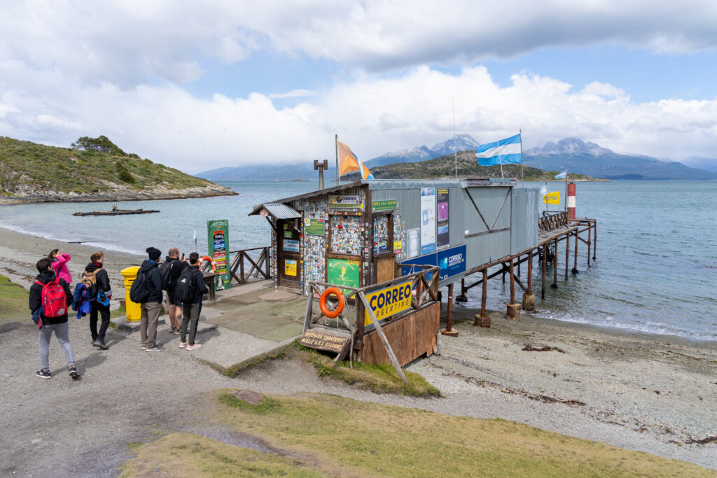 Tourists visiting “Post Office at the End of the World” in Tierra del Fuego National Park, Ushuaia, Tierra del Fuego, Argentina.