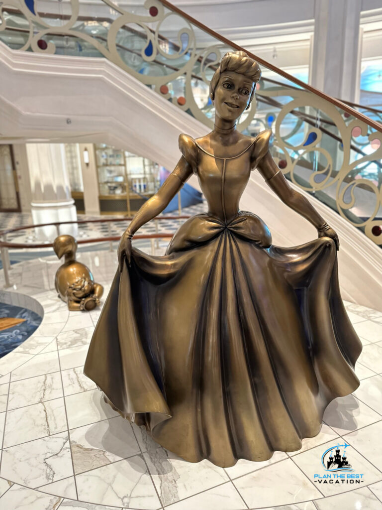 cinderella and lucifer statue in disney wish cruise ship atrium