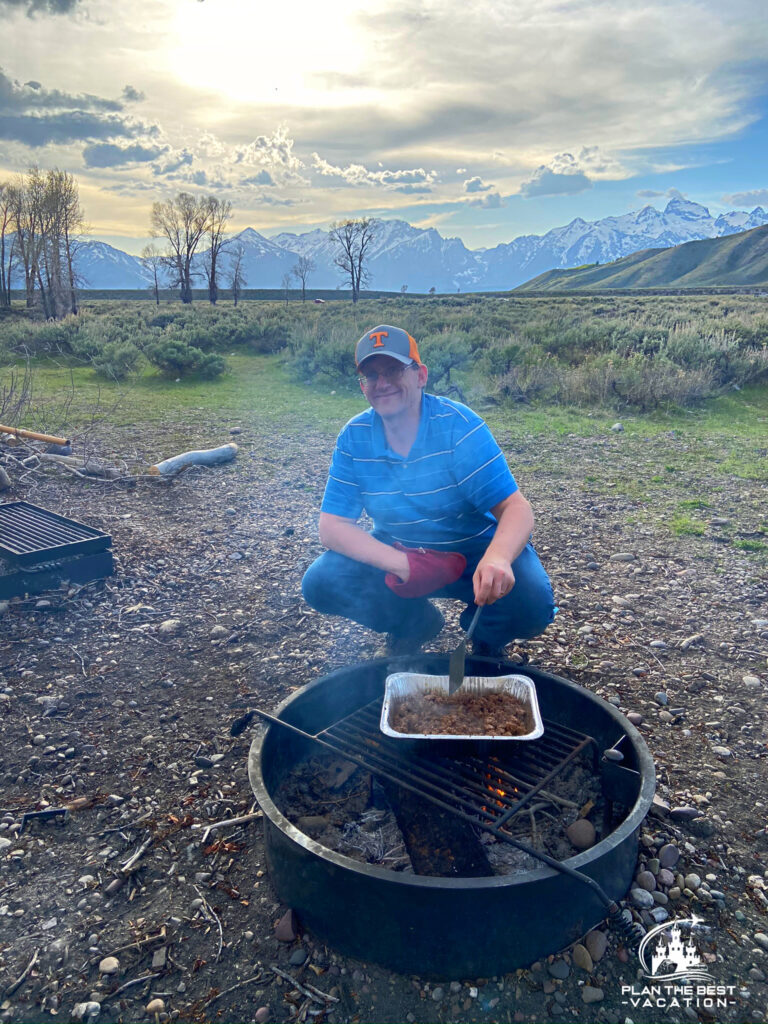 cooking over fire while camping in grand tetons wyoming