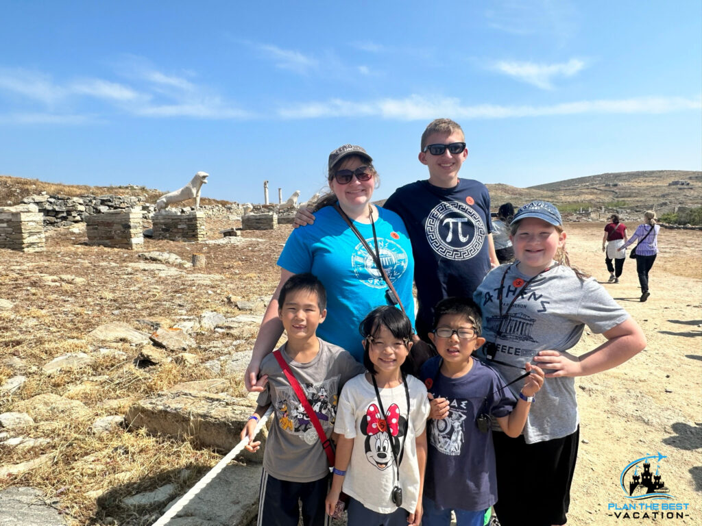 kids in front of iconic lions at delos archeaological park in mykonos greece