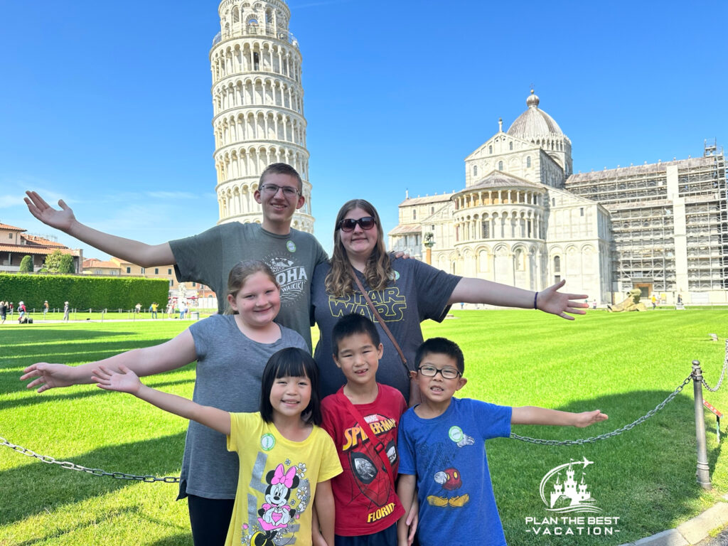 kids in front of leaning tower of pisa in italy