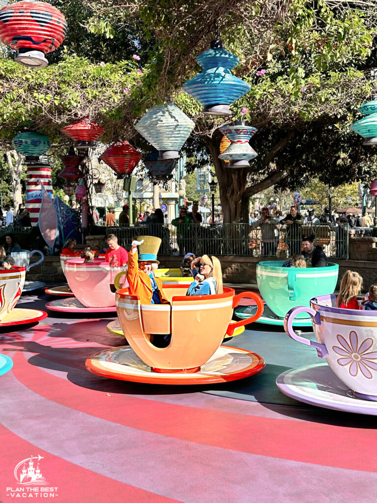 mad hatter and alice in wonderland riding tea cups ride at disneyland california