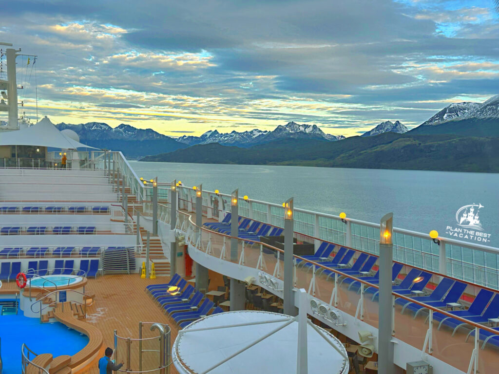 norweigan star cruise ship with gorgeous snow capped andes mountains behind with sunrise in the chilean fjords