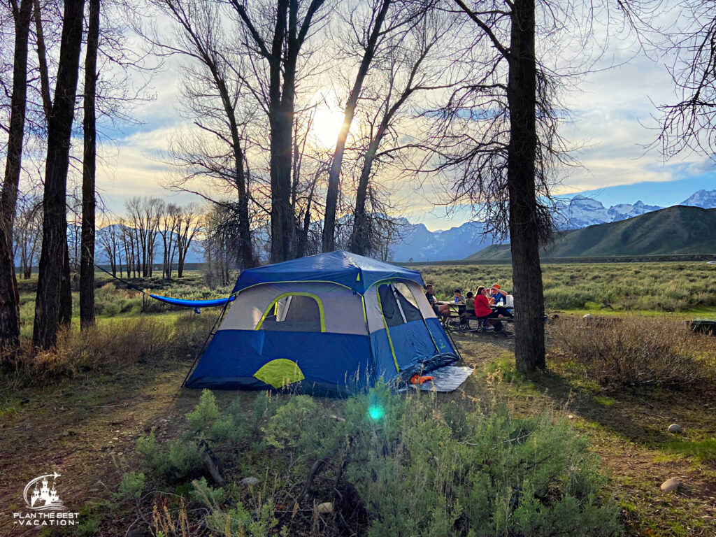 peaceful family camping with mountains behind