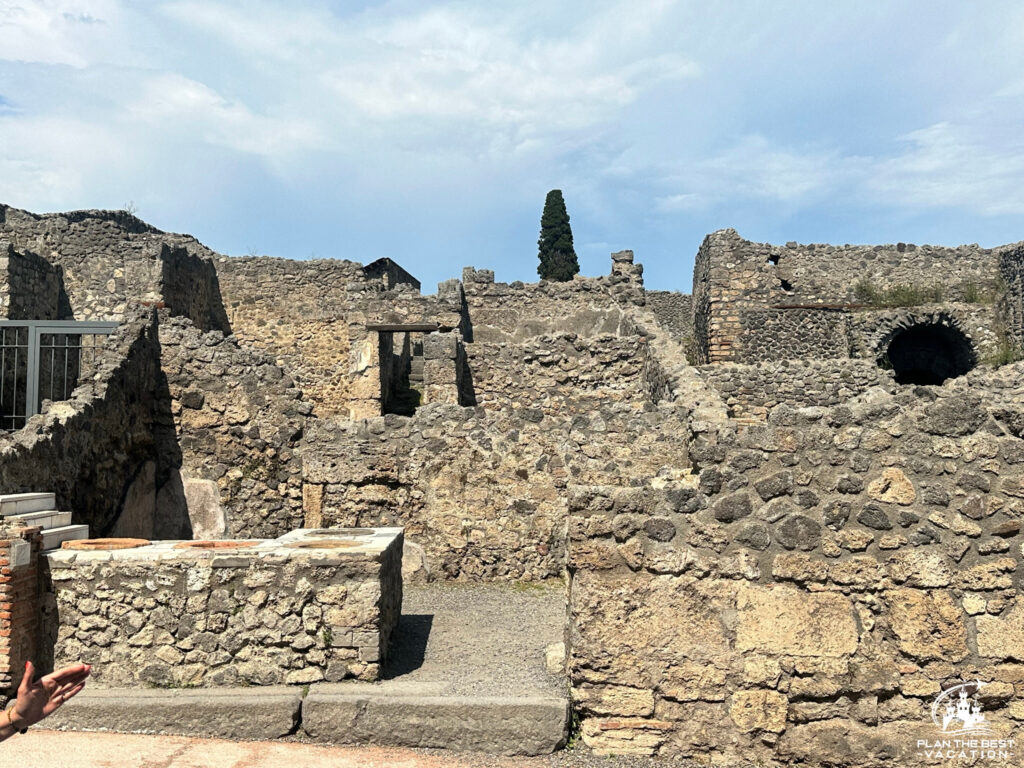 ruins of homes and businesses along the street of pompeii italy