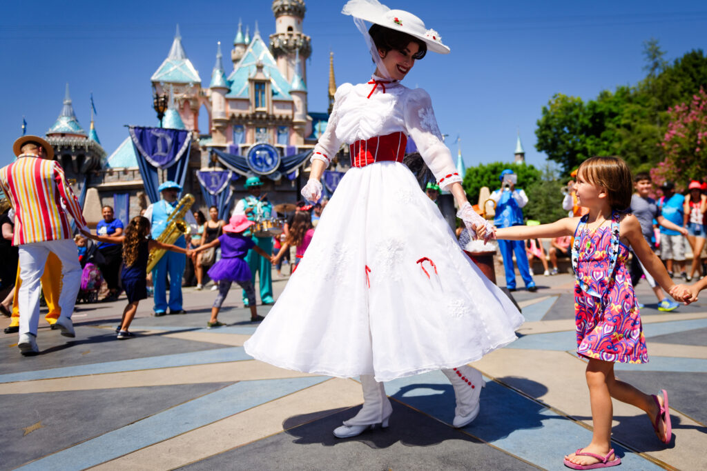 Mary Poppins with child in front of Disneyland Annaheim California Sleeping Beauty Castle