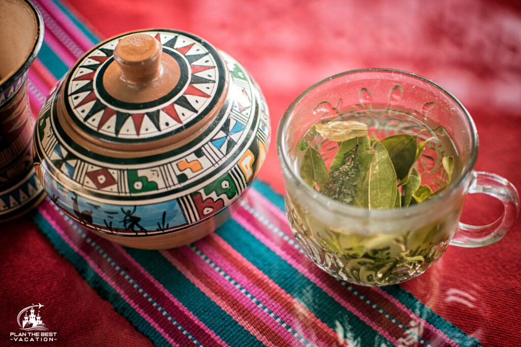 A cup of coca tea with coca leaves in Peru