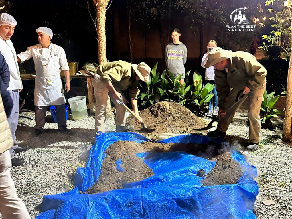 covering Pachamanca with tarp and dirt to allow it to cook in the earth like the Incans did