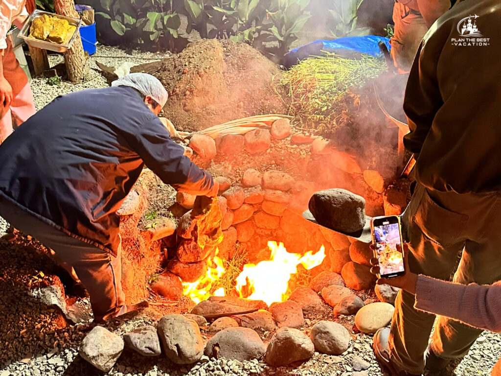 getting pit hot to make traditional peruvian food in peru