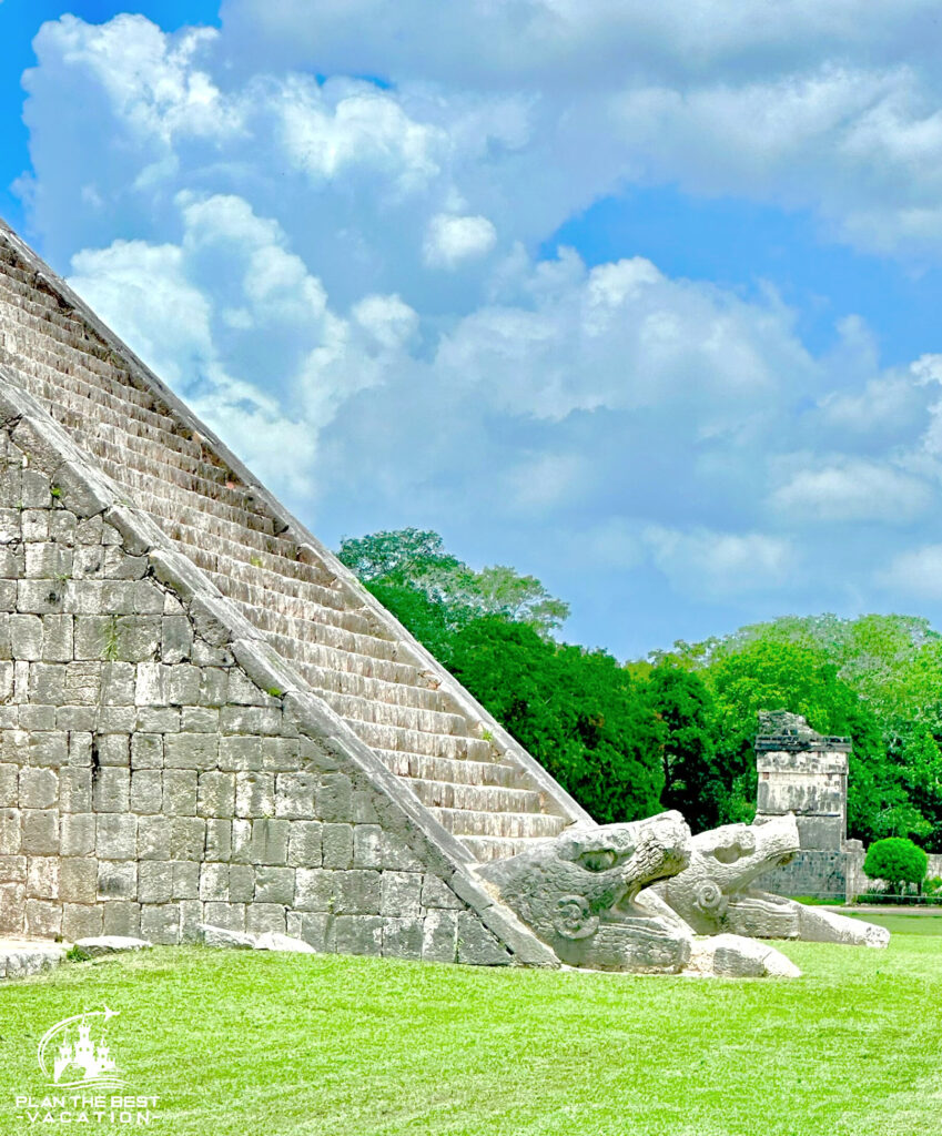 iconic snake heads at base of stairs mayan temple chichen itza